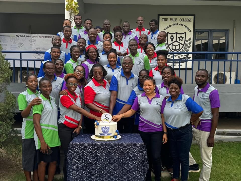 Members of The Vale College community gathered around a thirtieth-anniversary cake