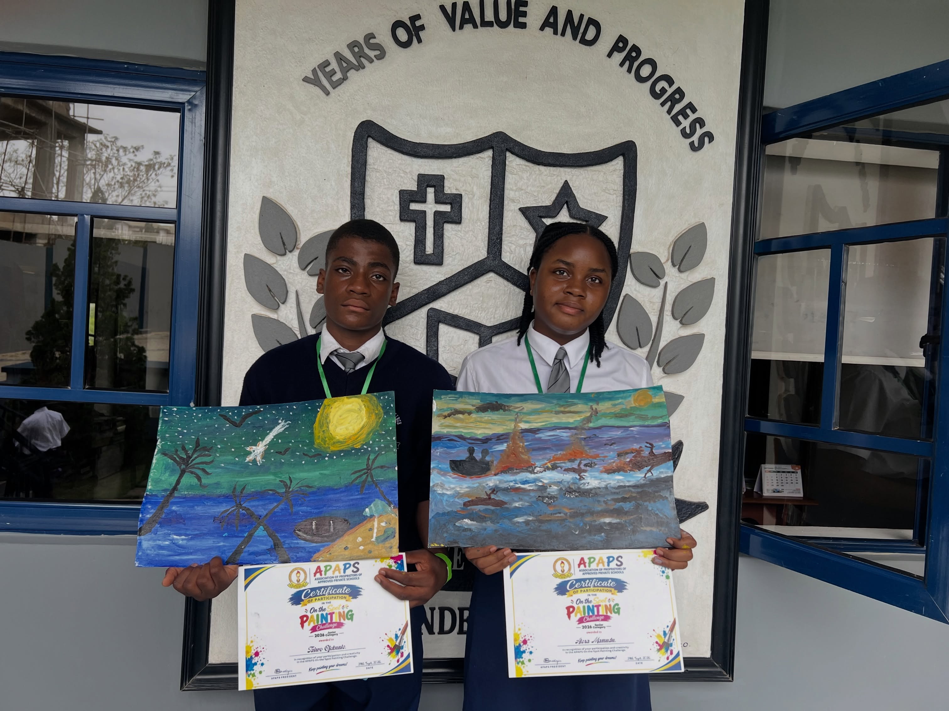 Two Vale College students displaying award-winning paintings